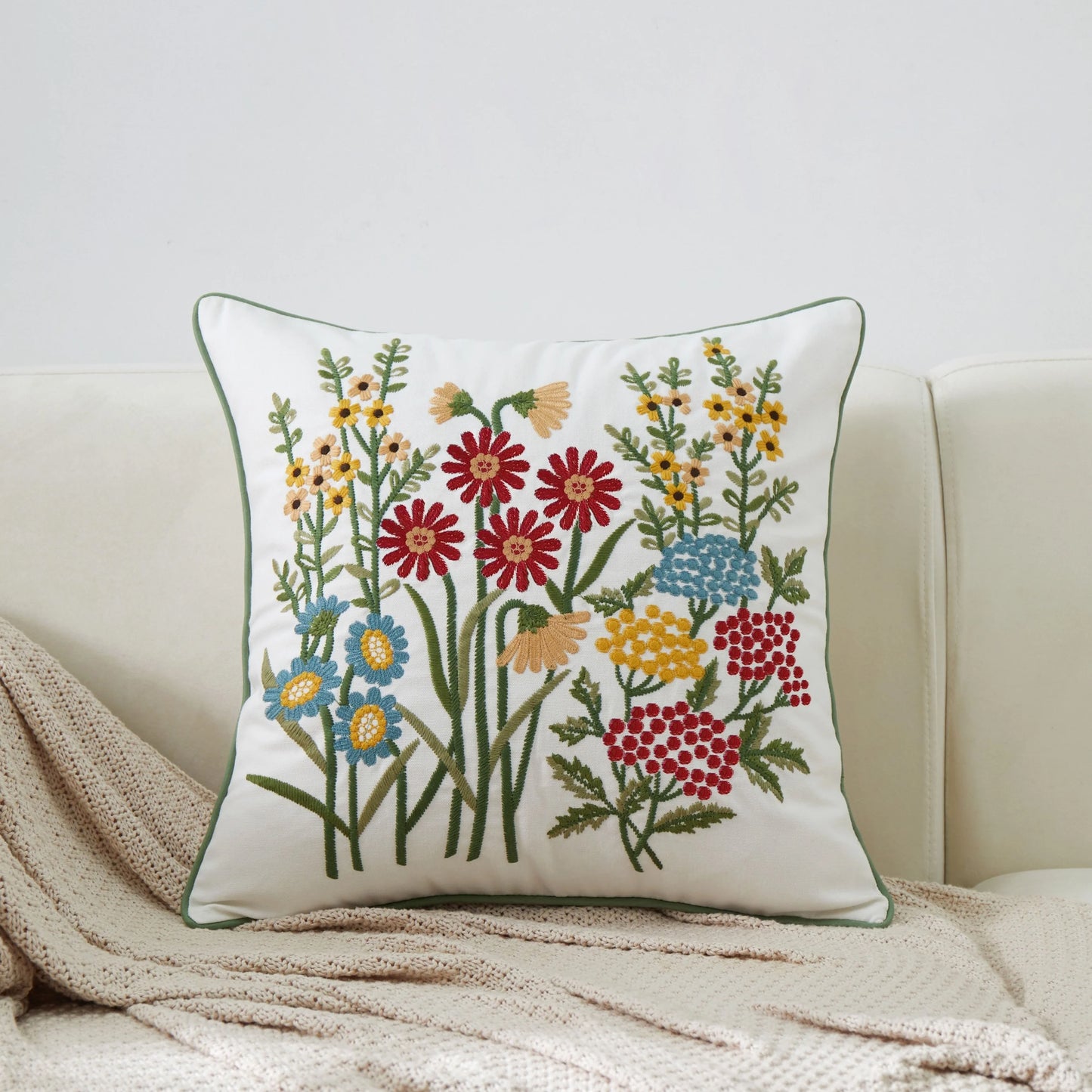 Decorative pillow with floral embroidery on a couch