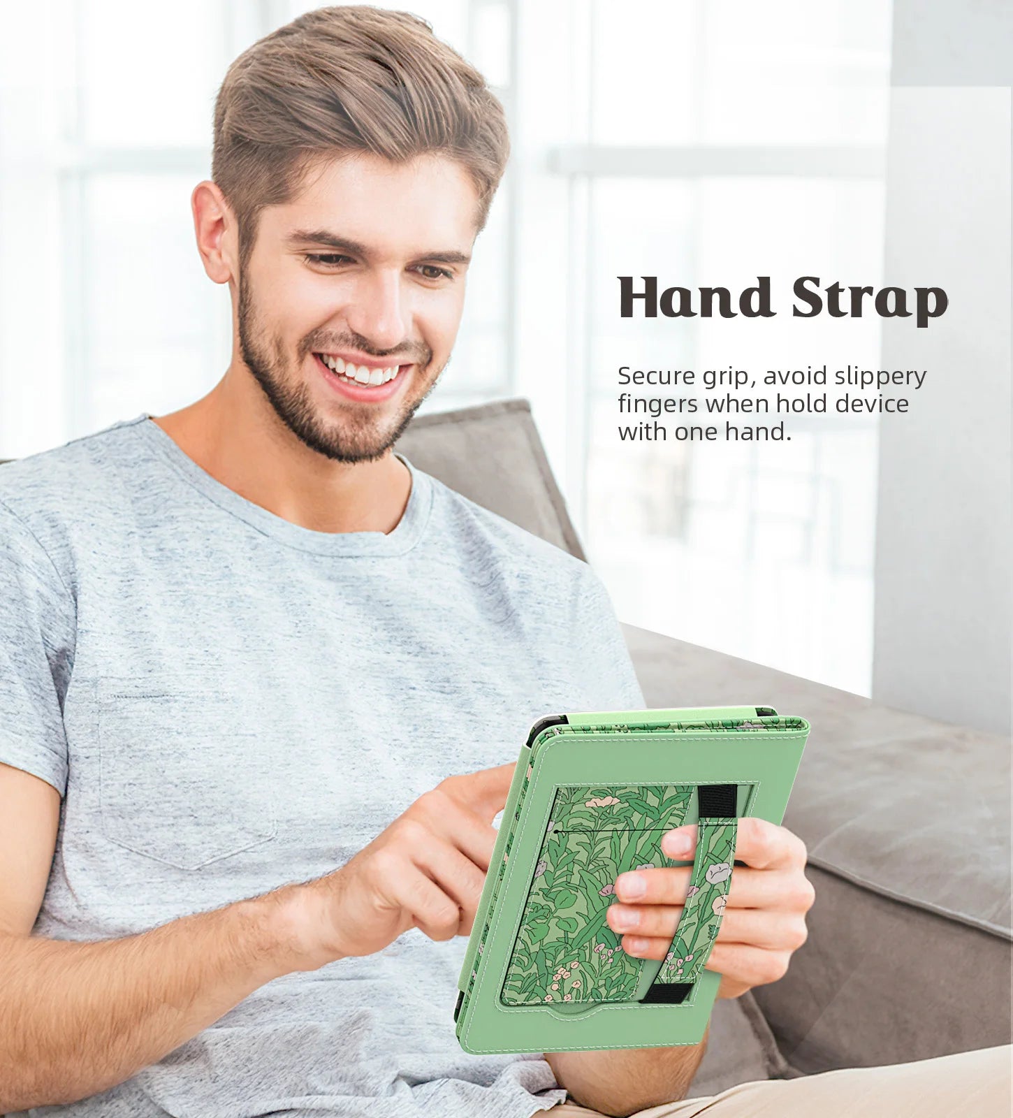Man holding a green device with a hand strap feature, sitting on a couch.