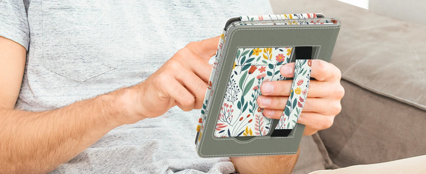 Person holding a tablet with a floral case on a couch